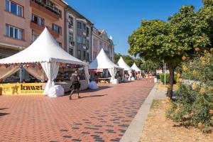 a row of white tents on a brick street at Dany's Apartments in Varna City