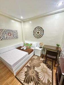 a living room with a bed and a table at BACKDOOR VILLA in Baler