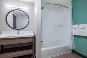 a bathroom with a sink and a mirror at ECHO Suites Extended Stay by Wyndham Houston Pasadena Fwy Pl in Pasadena +23 photos