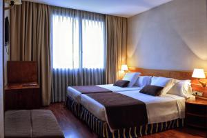 バルセロナにあるITC Barcelona By Soho Boutiqueの大きなベッドと窓のあるホテルの部屋