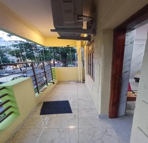 a corridor of an office building with a balcony at Sun Shine Guest House in Puducherry