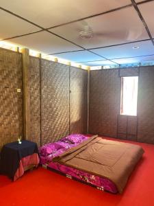 a room with a bed in the corner of a room at Green View Homestay & Jungle Trekking in Bukit Lawang
