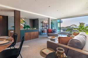 a living room with a couch and a view of the ocean at Suite Deluxe Samil in Vilamar