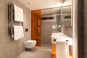 a bathroom with a toilet and a sink at Suite Deluxe Samil in Vilamar +27 photos