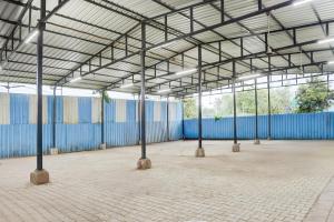an empty building with a large roof with poles at SPOT ON Hotel Royal Inn in Chandrapur +23 photos