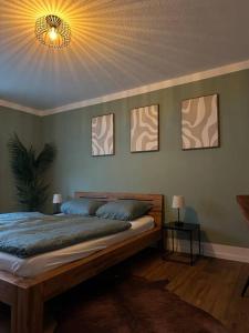 a bedroom with a bed with a light on the ceiling at Central Hideaway Garden, Parking, Cinema,4,5rooms in Zürich