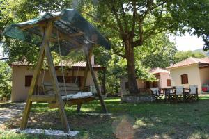 a swing set in the yard of a house at Dodis Village in Platanias