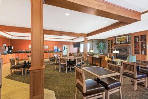a dining room with tables and chairs at MainStay Suites Stanley in Stanley