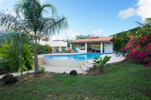 a house with a swimming pool in a yard at Bella Noni B&B in Aguadilla