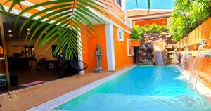 a swimming pool in front of a house at WOWLAND Luxury Pool Villa Pattaya Walking Street 6 Bedrooms in Pattaya South
