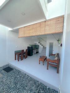 a living room with chairs and a table at Kaktus Boutique Apartments Bali - ADULTS ONLY in Legian