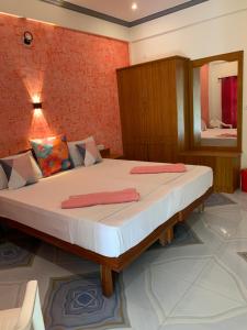 a bedroom with a large bed with a mirror at Anby Beach resort in Kovalam