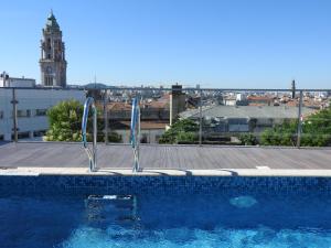 a large swimming pool with a blue sky at Porto Náutico & Spa in Porto