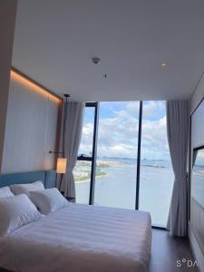 a bedroom with a bed with a view of the water at Alacarte Hạ Long Bích Ngọc in Ha Long