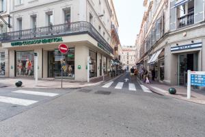 an empty city street with buildings and a street sign at The Cosmopolitan Lodge in Cannes