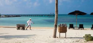 a man pushing a cart on the beach at Nizuc Resort & Spa in Cancún