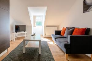 a living room with a couch and a table at Town Centre Apartment with FREE Parking in Loughborough