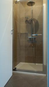 a shower with a glass door in a bathroom at Il Melograno B&B in Castellaneta Marina 