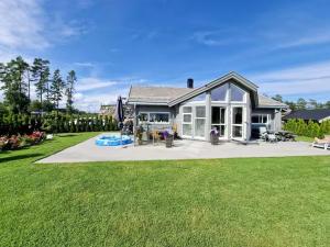 a house with a large yard in front of it at Stylish Cabin Experience In Beautiful Surroundings in Færvik