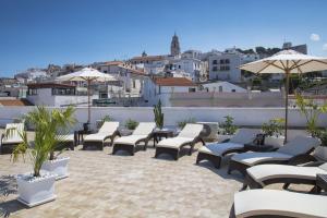 a patio with chairs and umbrellas on a roof at Relais La Pretura in Vieste