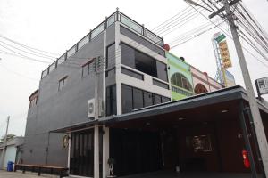 a gray building with a lot of windows at Peema Villa ภีมะ วิลล่า in U Thong +135 photos