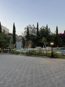a parking lot with trees and a park at بستان الأحلام in Abha