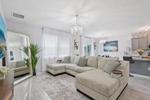 un salon avec un canapé et une table dans l'établissement Lakefront Luxury Retreat 5BR, à Jacksonville