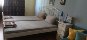 a bedroom with a bed with a white frame at Стая за двама в град Бургас in Burgas City