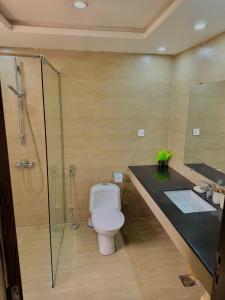 a bathroom with a toilet and a shower and a sink at Dahlia By T2R, 3BHK Bahria Town Phase 7, Close To DHA-1 Islamabad in Rawalpindi