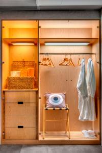 a room with a closet with shelves and hangers at Nissaki Beach Hotel in Naxos Chora