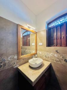 a bathroom with a sink and a mirror at The Ridge Colonial Villa - Ahangama in Ahangama +57 photos