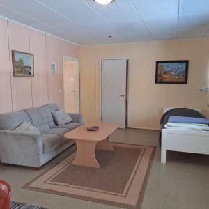 a living room with a couch and a coffee table at Karhunkierros Apartment in Hautajärvi