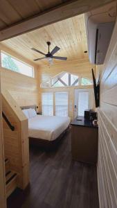 a bedroom with a bed and a ceiling fan at 057A Brand New Cozy Cabin with Loft & King bed near Grand Canyon South Rim in Valle