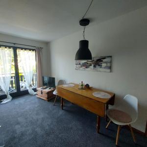 a living room with a wooden table and chairs at Landhaus Brüne in Bad Wildungen