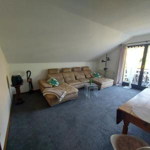 a living room with a couch and a table at Landhaus Brüne in Bad Wildungen +3 photos