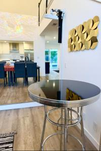 a glass table in the middle of a living room at Santa Monica Beach Retreat with Hot Tub, Billiards & Grill in Los Angeles +2 photos