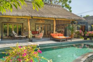 a villa with a pool in front of a house at Bali Bagus Villa in Amed