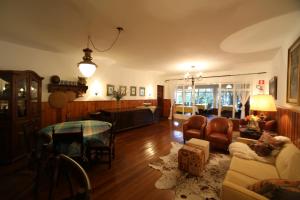 a living room with a couch and a table at Europa Hotel in Campos do Jordão