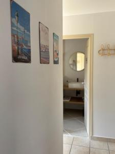 a bathroom with three pictures on the wall at Gîte Cosy TY CLEM cottage in Mouilleron-le-Captif +41 photos