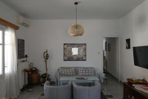 a living room with a couch and a table at Kamares Bay View in Sifnos