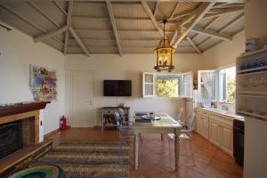 a dining room with a table and a fireplace at Fisherman's Cottage in Kalamakia