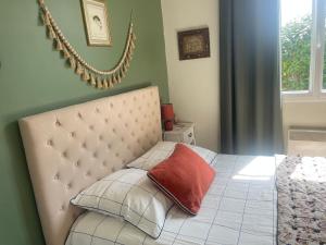 a bedroom with a bed with a pillow on it at " Goarem Bihan" Villa de Charme Front de Mer in Plouarzel