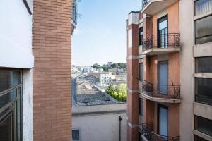 a view of a city from between two buildings at Smile House in Matera