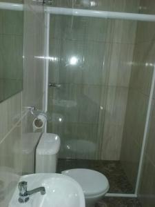a bathroom with a shower and a toilet and a sink at Trilhos Hotel in Sao Paulo +28 photos