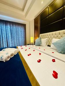 a large bed with red rose petals on it at Sea view Serenity Negombo in Negombo +10 photos