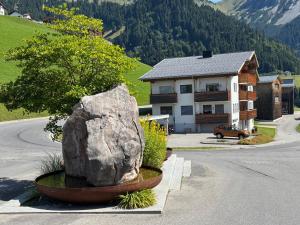 a large rock sitting on the side of a road next to a house at Stern Apartments Fontanella in Fontanella
