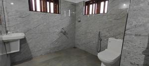 a bathroom with a toilet and a sink at Traditional Kerala house, Kannur-Thalassery in Tellicherry +19 photos