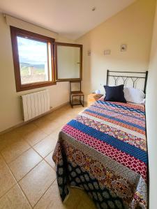 a bedroom with a bed and a window at La PenAlta - Allotjament enoturístic - Vilanova de Prades in Vilanova de Prades