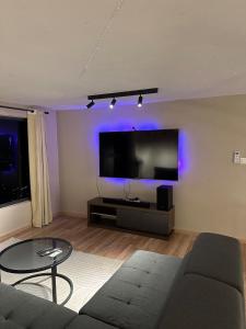 a living room with a couch and a flat screen tv at Arte Cheras in Kuala Lumpur