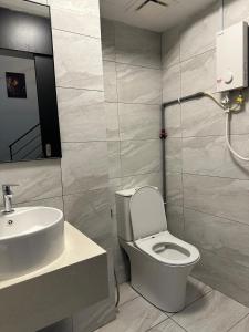 a bathroom with a toilet and a sink at Arte Cheras in Kuala Lumpur +14 photos